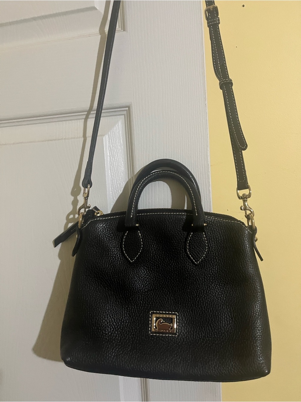 Dooney & Bourke small satchel with leather removal strap.